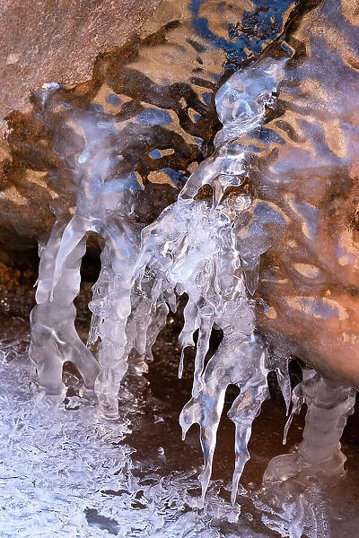 USA, Utah. Ice formations with sky and canyon wall reflections, Arches National Park