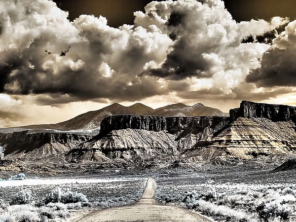 USA, Utah. Infrared of road leading to Fisher Tower and large clouds