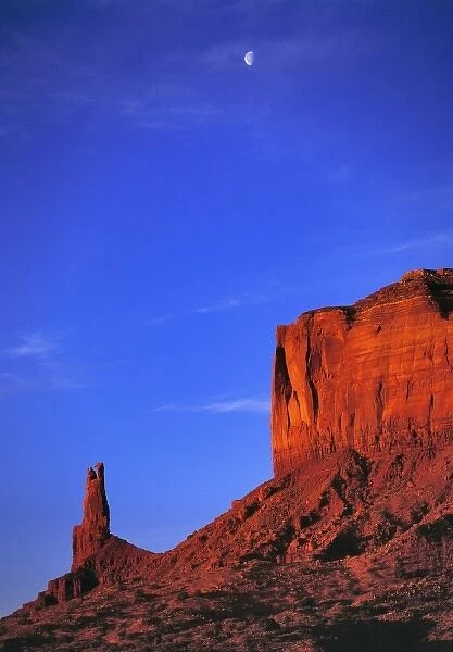 USA, Utah, Monument Valley. A half-moon greets the dawn near Brighams Tomb in Monument Valley