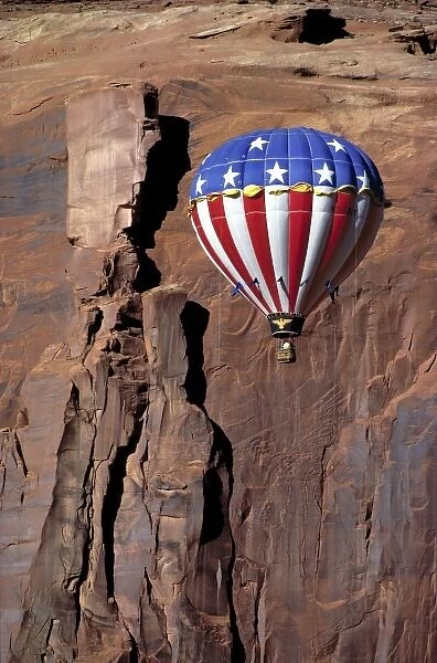 USA, Utah, Monument Valley. A hot-air balloon floats against a rock wall in Monument Valley, Utah