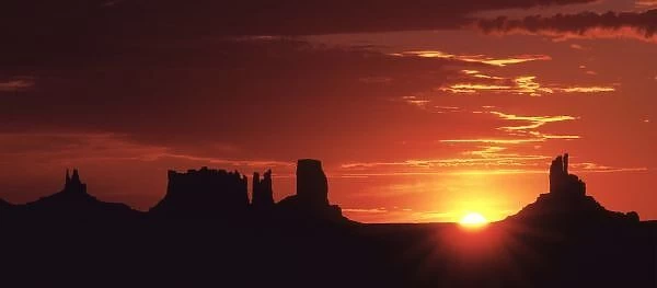 USA, Utah, Monument Valley. The rising sun silhouettes buttes in Monument Valley, Utah