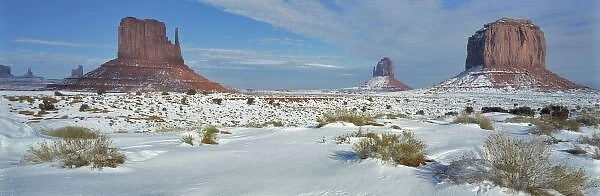 USA, Utah, Monument Valley. Sagebrush shows through the snow in front of Merrick Butte