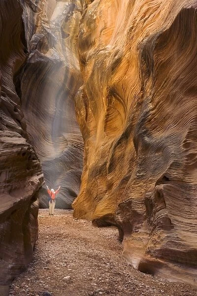 USA, Utah, Willis Creek. Woman hiker admiring slot canyon rock formations