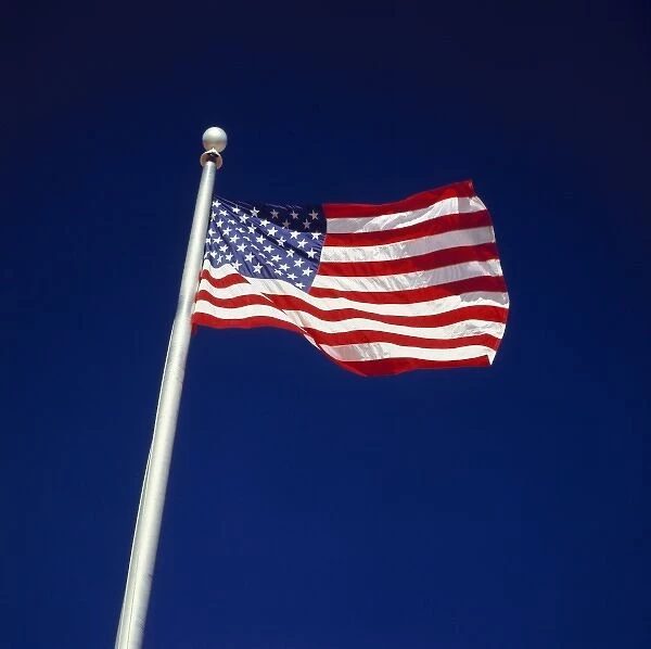 USA, Utah, Zion NP. The American flag waves against a deep blue sky, at Zion Park Headquarters