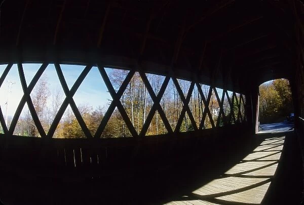 USA, Vermont. Covered bridge and fall foliage