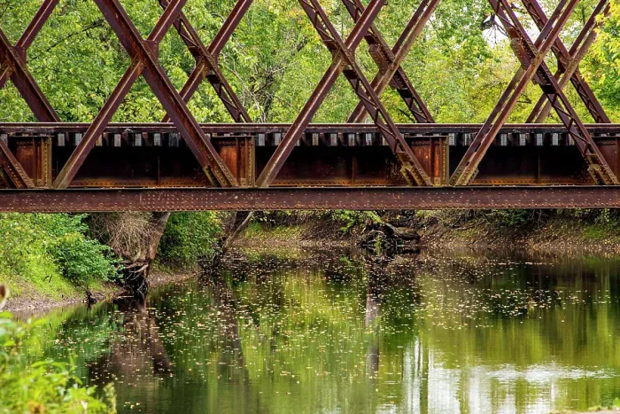 Framed Print : USA, Vermont. Rusted train bridge with tracks over Otter Creek