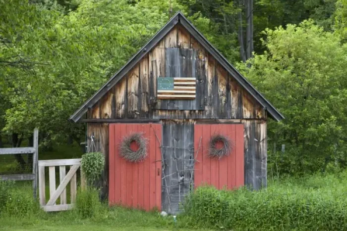 Framed Print : USA, Vermont, Searsburg, Rustic wooden cottage at forests edge on spring evening