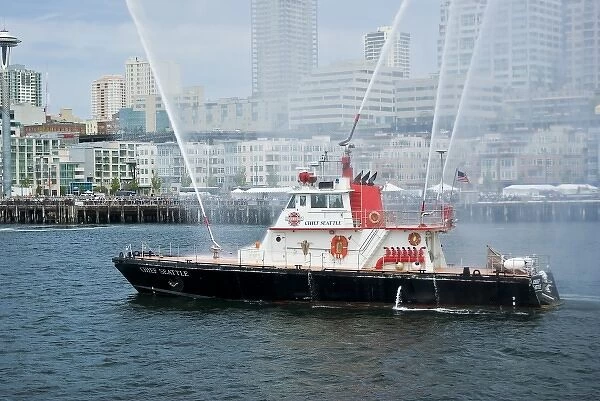 USA, WA, Seattle. Fireboat Chief Seattle with celebratory spray in Elliot Bay