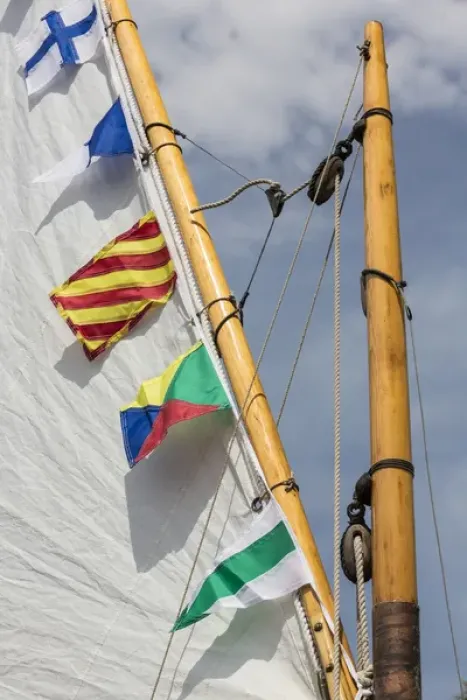Framed Print : USA, Washington. Boat sail and flags at Bainbridge Island Wooden Boat Festival. Credit as