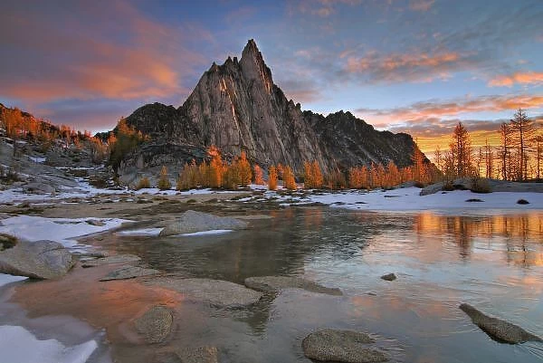 USA, Washington, Cascade Mountains. Prusik Peak from frozen Gnome Tarn in the Enchantment Lakes