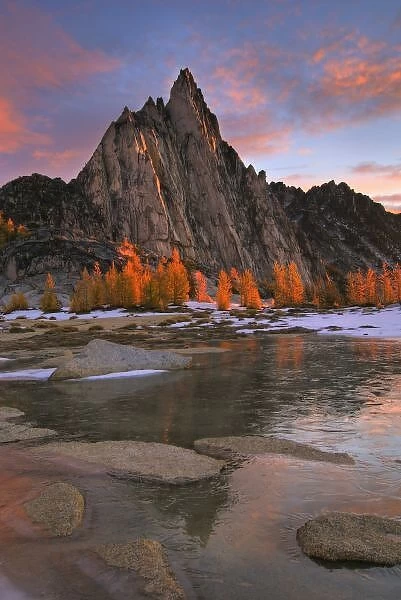 USA, Washington, Cascade Mountains. Prusik Peak from frozen Gnome Tarn in the Enchantment Lakes