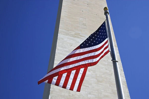 USA, Washington DC. American flag and the Washington Monument