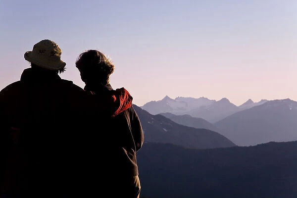 USA, Washington, Mount Baker. Two women view mountain scenery in Snoqualmie National Forest