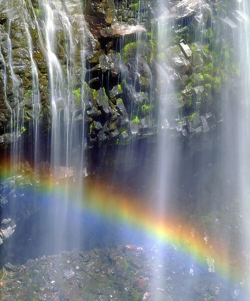USA; Washington; Mount Rainer National Park; Rainbow at the base of a waterfall