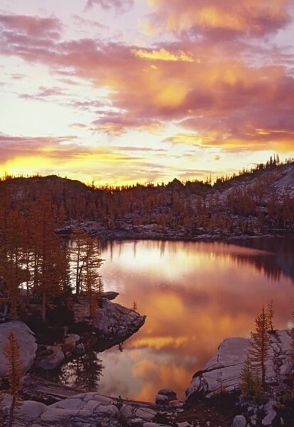 USA, Washington, North Cascade Mountains. Sunrise clouds reflect on Rune Lake, Sunrise