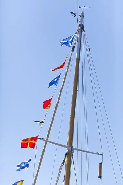 USA, Washington, Port Townsend. Sailboat mast flying semaphore flags at a Wooden Boat Show