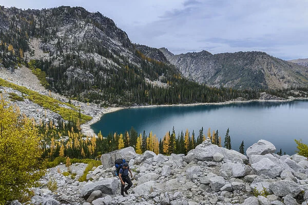 USA, Washington State, Alpine Lakes Wilderness. Backpacker starts up Asgard Pass. (MR)