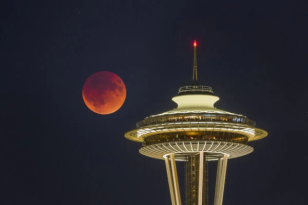 USA, Washington State. Blood moon (lunar eclipse) rises over Seattle Space Needle
