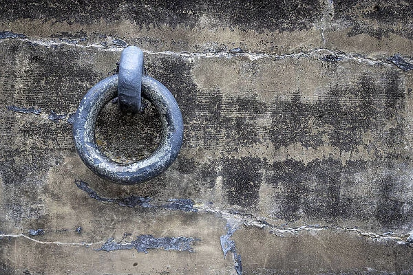 USA, Washington State, Fort Flagler State Park. Metal ring on weathered concrete wall