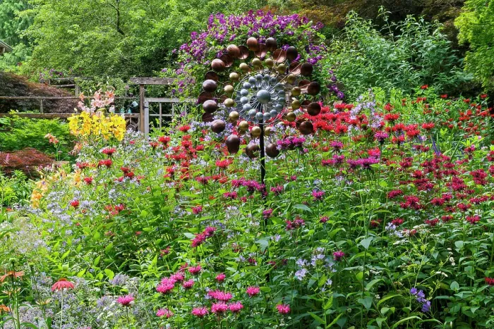 Framed Print : USA, Washington State, Sammamish. Summer perennial flower garden with cone flowers, zinnias. Beebalms, Rebecca. Coleus, Japanese grasses and lawn art, wind wheel Framed Print : USA, Washington State, Sammamish. Summer perennial flower garden with cone flowers, zinnias. Beebalms, Rebecca. Coleus, Japanese grasses and lawn art, wind wheel
