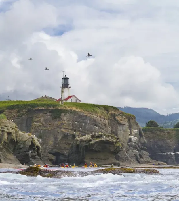 Framed Print : USA. Washington state. Sea Kayakers paddle beneath the lighthouse on Tatoosh Island