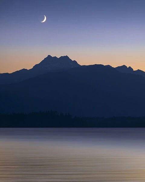 USA, Washington State, Seabeck. Crescent moon at sunset over Hood Canal and Olympic Mountains