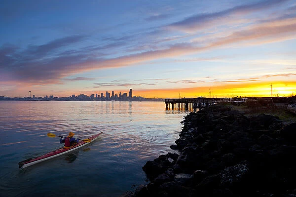 USA, Washington State, Seatte. Male sea kayaker in Elliot Bay, Seattle, WA at sunrise