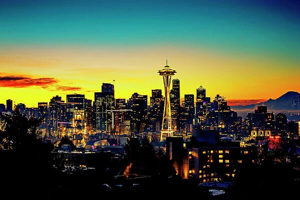 USA, Washington State, Seattle. Dawn on Seattle skyline from a park on Queen Anne Hill with Mt. Rainier in the background