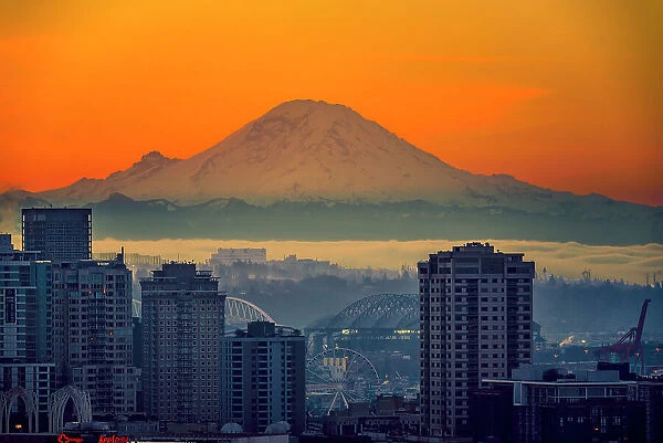 USA, Washington State, Seattle. Dawn on Seattle skyline from a park on Queen Anne Hill with Mt. Rainier in the background