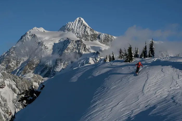 Framed Print : USA, Washington State. Skier challenged by wind-drifted snow with Mount Shuksan in background. (MR)