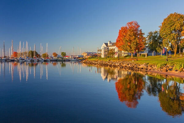 USA, Wisconsin. Fall colors reflected on the still waters of the harbor in Bayfield