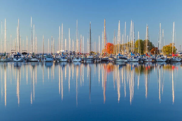 USA, Wisconsin. Panoramic view of Fall colors reflected on the still waters of the harbor
