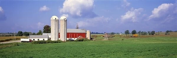 USA, Wisconsin, Washington Co. A farms red barn is brilliant against the green