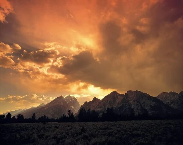 USA, Wyoming, Grand Teton NP. The Tetons are overshadowed by this beautiful sunset