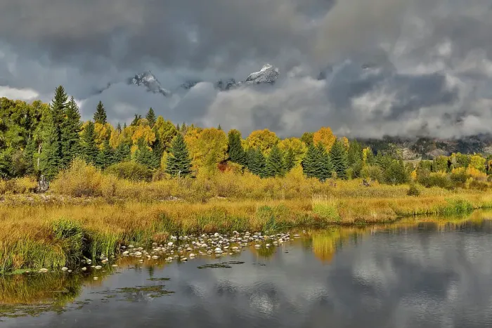 Framed Print : USA, Wyoming. Grand Tetons National Park view of Teton Mountains as they peak through the morning clouds from Schwabacher Landing in reflections