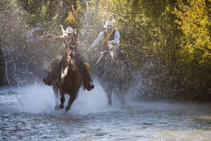 Framed Print : USA, Wyoming, Shell, The Hideout Ranch, Cowboy and Cowgirl on Horseback Running through the River Framed Print : USA, Wyoming, Shell, The Hideout Ranch, Cowboy and Cowgirl on Horseback Running through the River