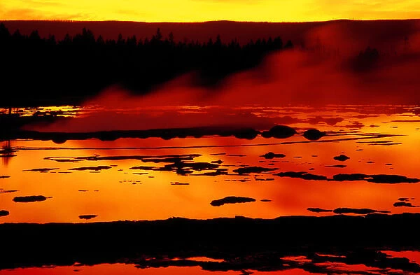 USA, Wyoming, Yellowstone National Park. Vapor flows from Grand Geyser at sunset