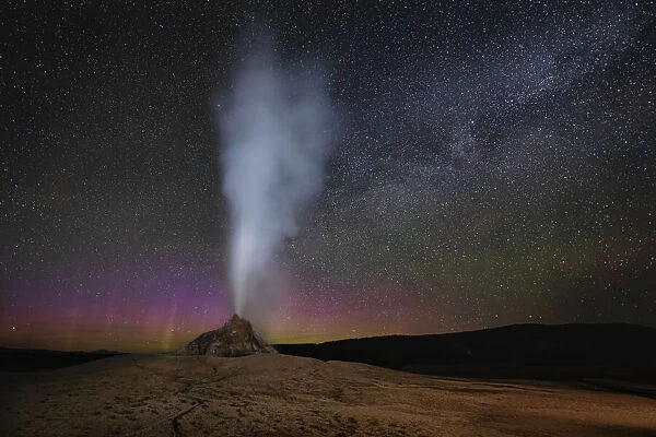 USA, Wyoming, Yellowstone National Park. Aurora and Milky Way above erupting White Dome