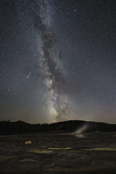 USA, Wyoming, Yellowstone National Park. Meteor streaks across Milky Way