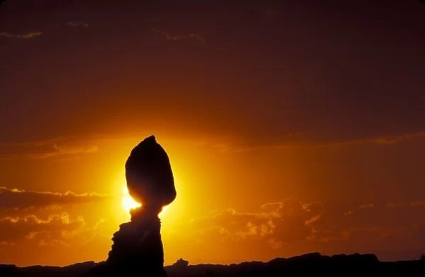 Utah, Arches National Park. Balanced Rock silhouetted at sunset