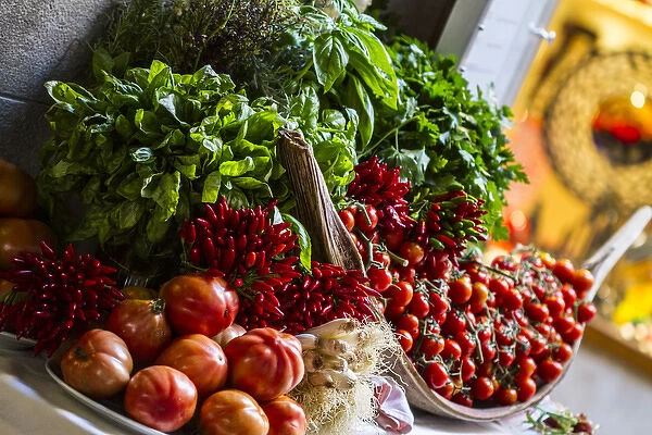 Venice, Italy. Bundle of Fresh Herbs, red Picante Peppers, onions, and tomatoes