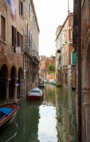Venice, Veneto, Italy - Buildings surrounded by the canals in Venice, Italy. Boats