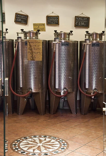 Venice, Veneto, Italy - A row of shiny metal vats containing wine for sale in bulk