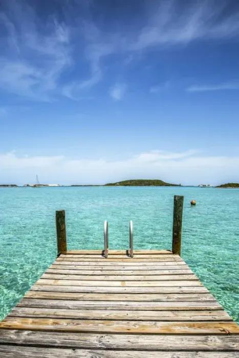 Framed Print : Vertical photo with a dock in the foreground, clear water and blue sky in the background Framed Print : Vertical photo with a dock in the foreground, clear water and blue sky in the background