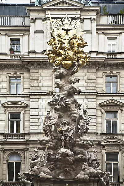 Vienna, Austria - Low angle view of an ornate religious sculpture in front of an old world building