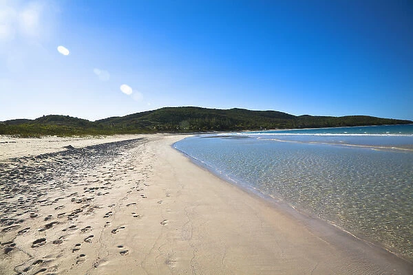 Vieques, Puerto Rico - Gentle waves are rolling up onto the white sands of a tropical beach