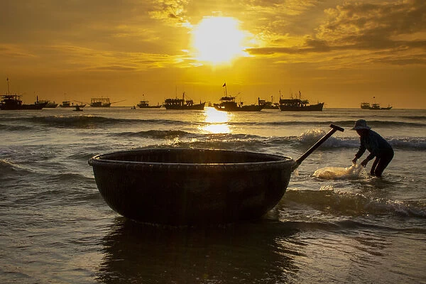Vietnam. Fishermen deliver the nights catch to the beach at Hoi An