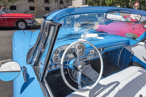 View into drivers seat of a classic convertible baby blue American car parked in