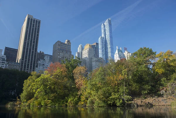 View of highrise buildings along Central Park South from inside Central Park on a sunny Fall day