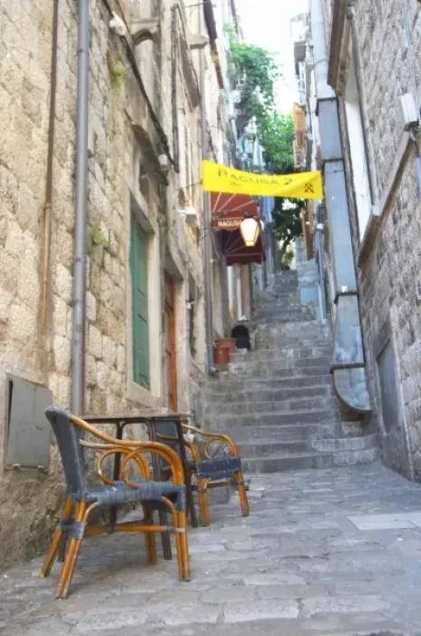 Framed Print : View from the Prijeko street up a narrow street with steep stairs. Two rattan chairs Framed Print : View from the Prijeko street up a narrow street with steep stairs. Two rattan chairs